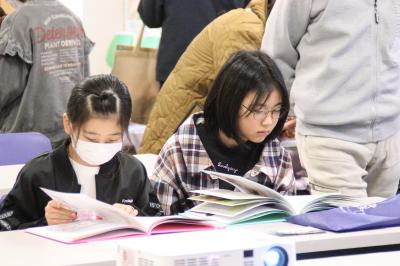 休憩中に盲導犬に関する図書を読む参加者